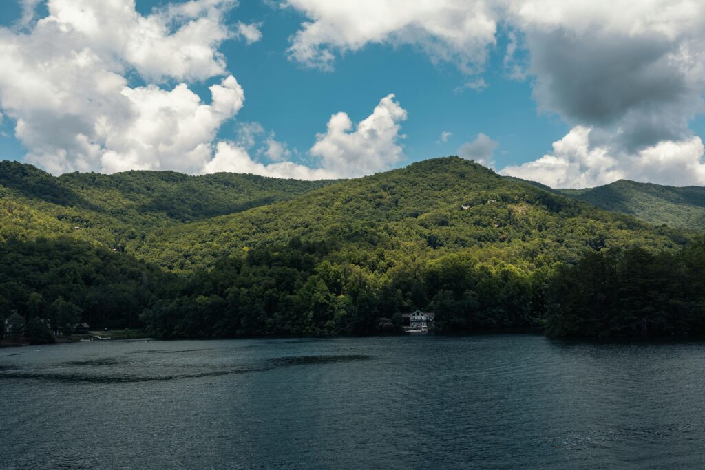 Picturesque Smoky Mountains and lake view under a vibrant sky in Gatlinburg, Tennessee.