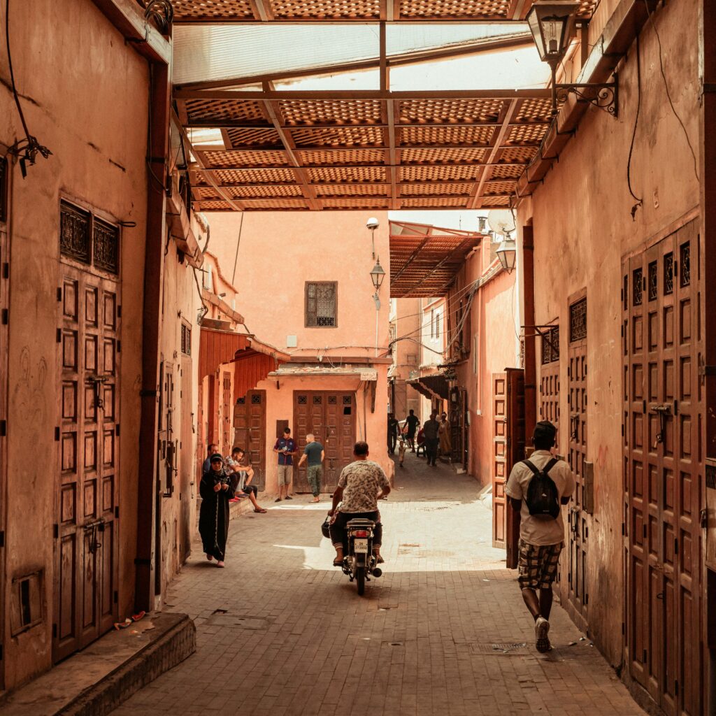 A vibrant alleyway in Marrakech, showcasing traditional architecture and local life.