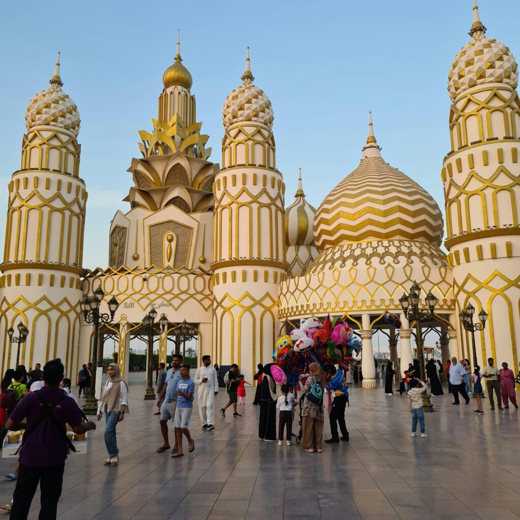 A colorful architectural landmark with tourists enjoying a vibrant atmosphere.