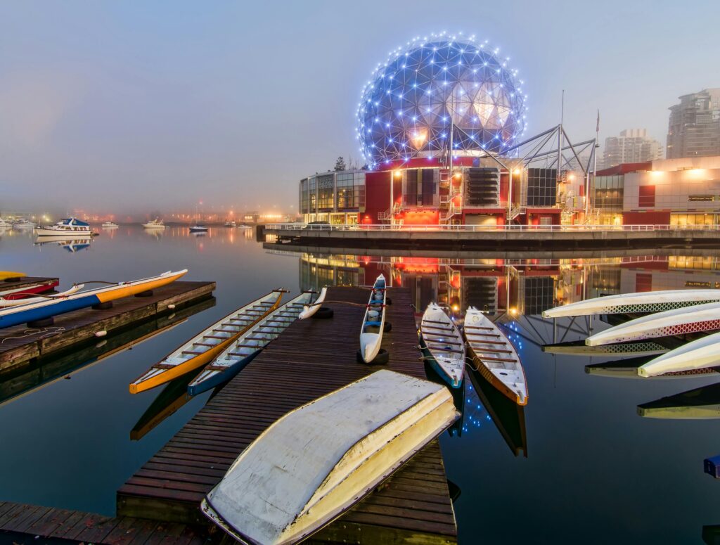 Enchanting view of Vancouver's Science World reflecting on calm waters at twilight.