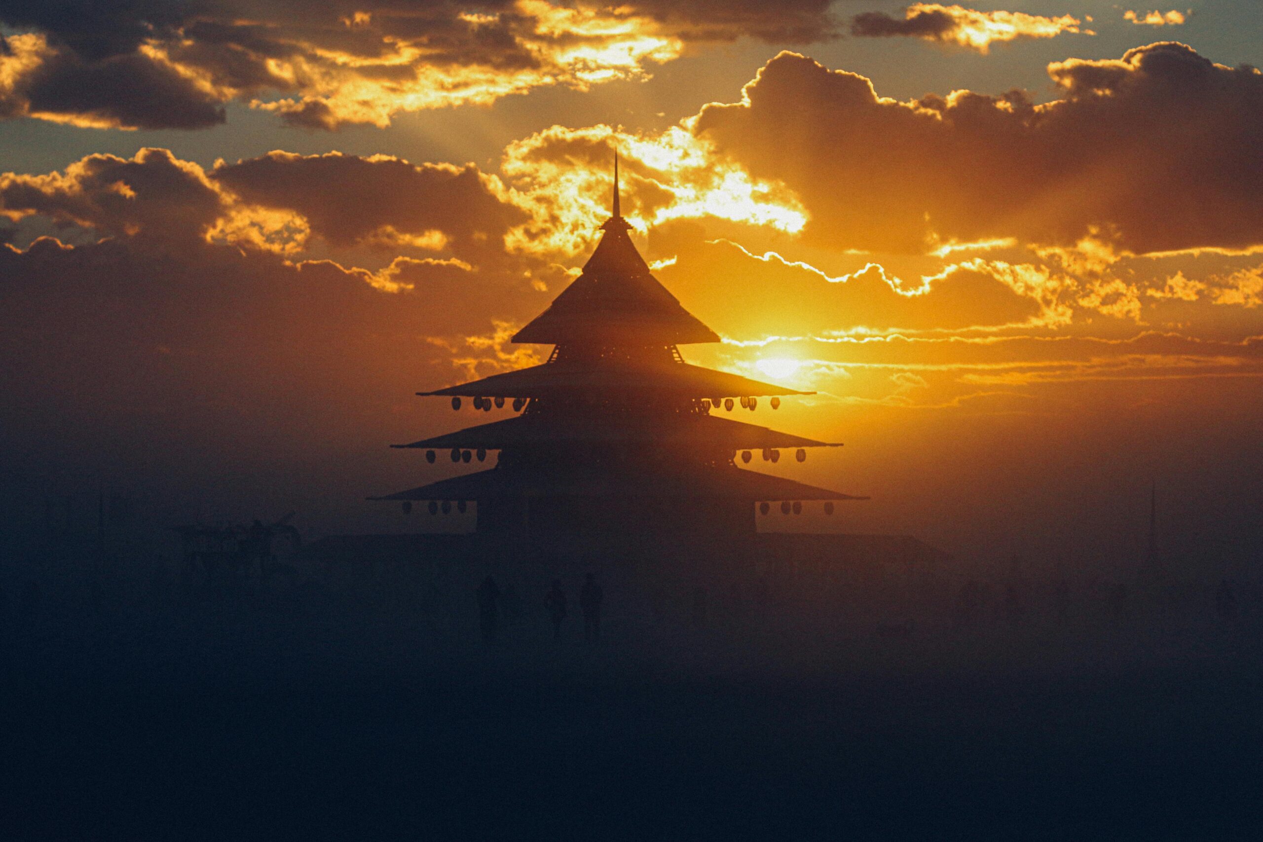 Dramatic silhouette of a pagoda during sunset at Burning Man festival, Nevada.