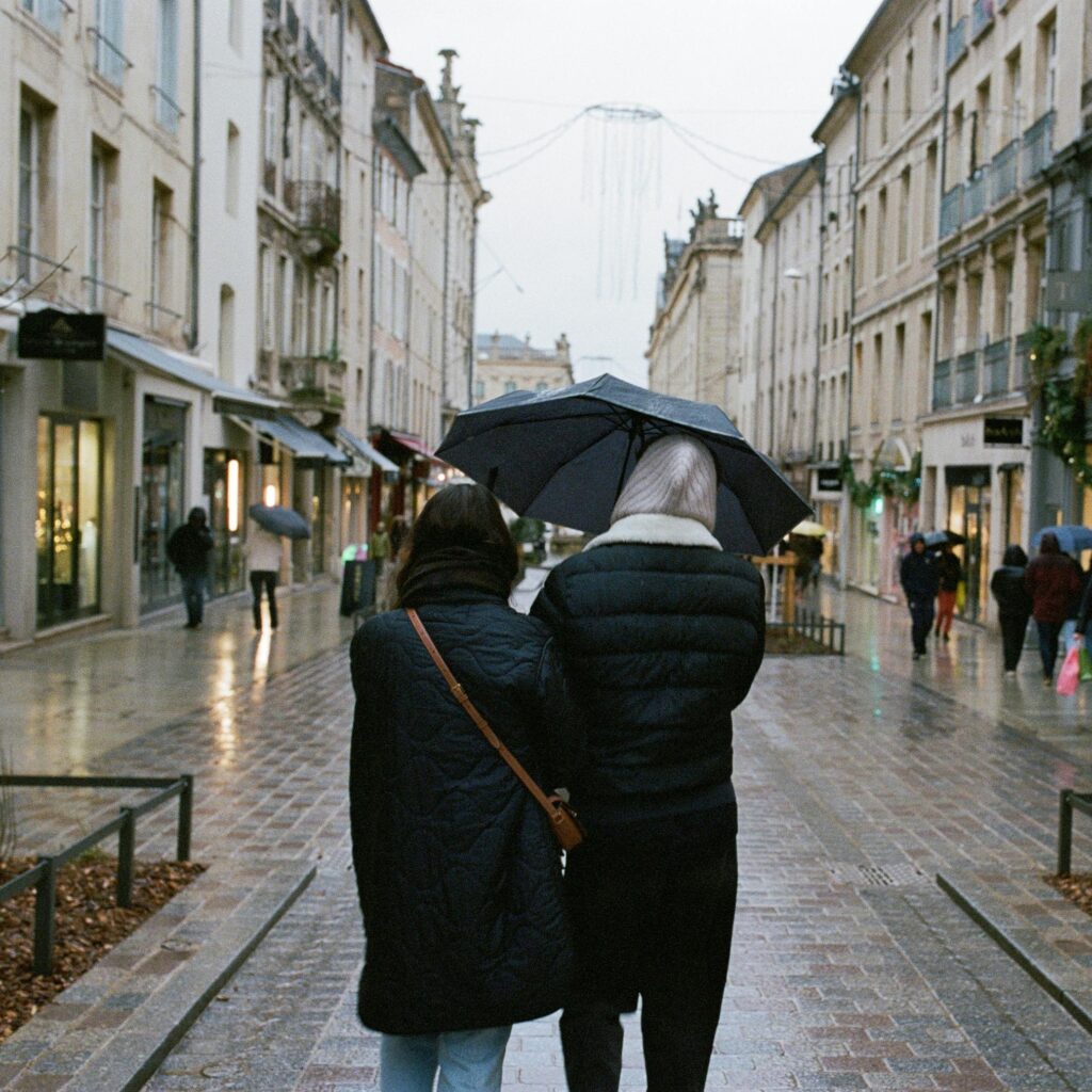 A couple walks under an umbrella on a rainy day in Nancy, France.