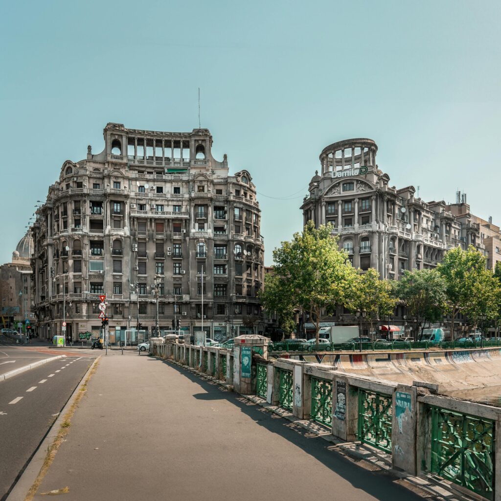Captivating view of historic buildings alongside the Dâmbovița River in Bucharest, Romania.