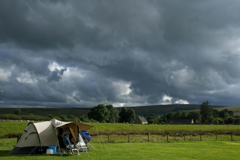 A campsite in Bellingham, England with dark clouds looming overhead, depicting an impending storm.