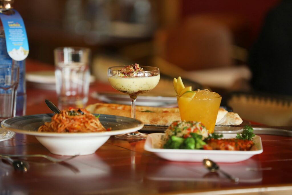 A diverse spread of Indian and Italian dishes in a modern Bengaluru restaurant setting.