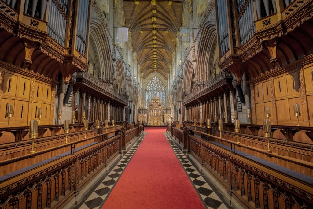 Beautiful interior of Selby Abbey featuring Gothic architecture and vibrant red carpet.