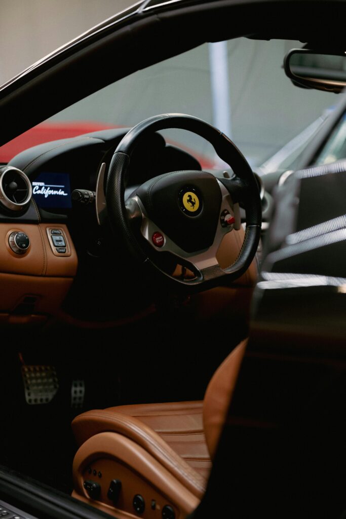 Close-up of a luxury car interior showing leather seats and steering wheel.