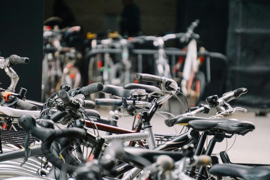A busy urban bicycle parking lot with various bikes securely parked.