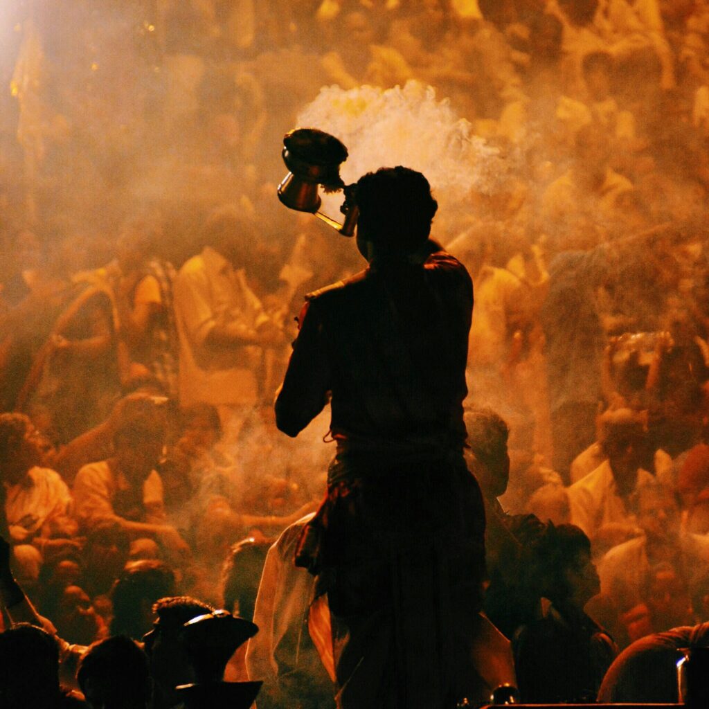 A vibrant Hindu prayer ritual with incense smoke in Mumbai, highlighting spirituality and community.