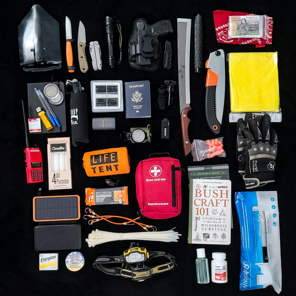 Survival gear essentials arranged as a flat lay for camping and hiking preparedness.
