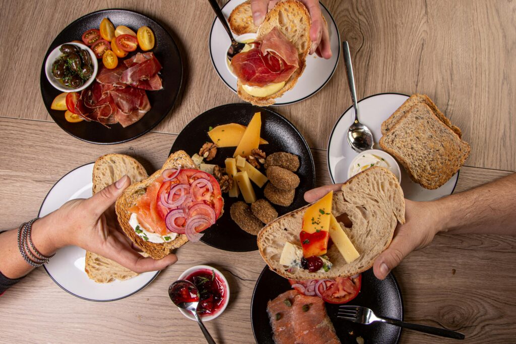 Delicious breakfast display with artisan breads and various gourmet toppings.