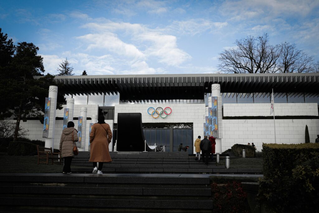 Visitors at the entrance of the Olympic Museum in Lausanne, Switzerland on a clear day.