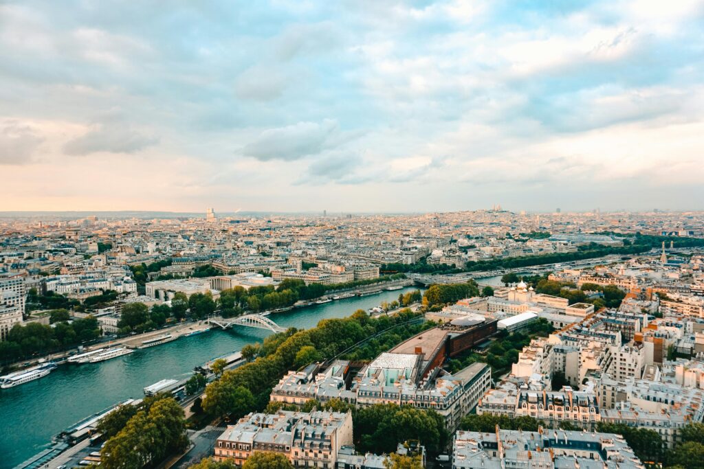 A stunning aerial view of Paris, showcasing the Seine River and iconic landmarks during sunset.