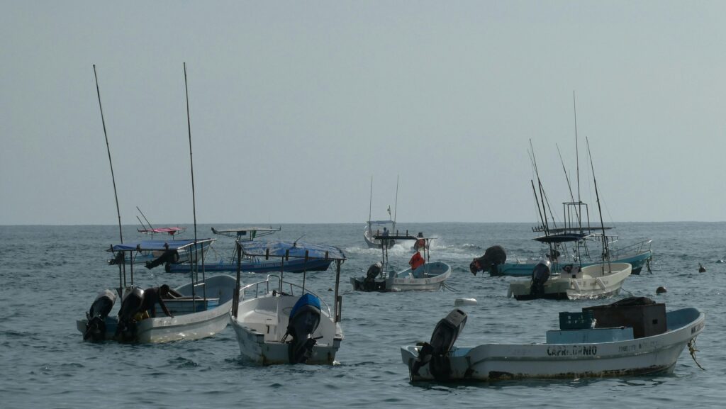 Leisurely view of fishing boats floating on the ocean in Puerto Escondido, Mexico.